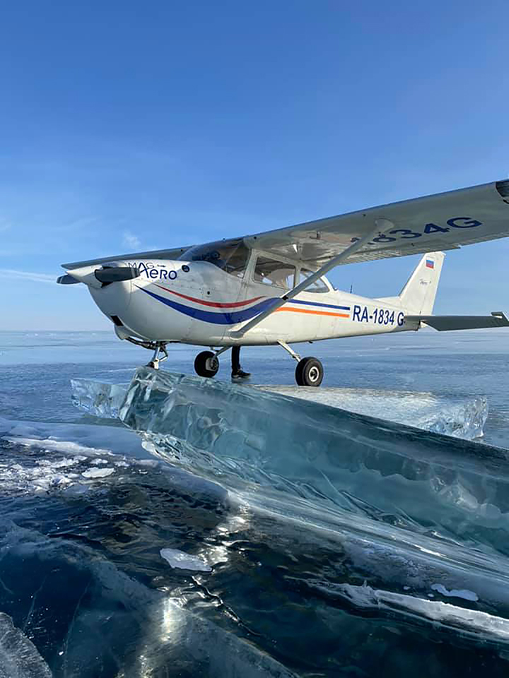 Moment plane lands on frozen surface of the world’s deepest lake