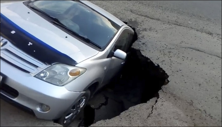 Car in pothole