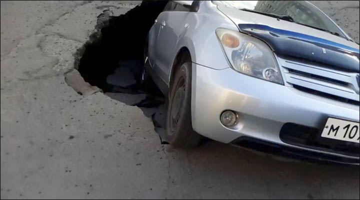 Car in pothole