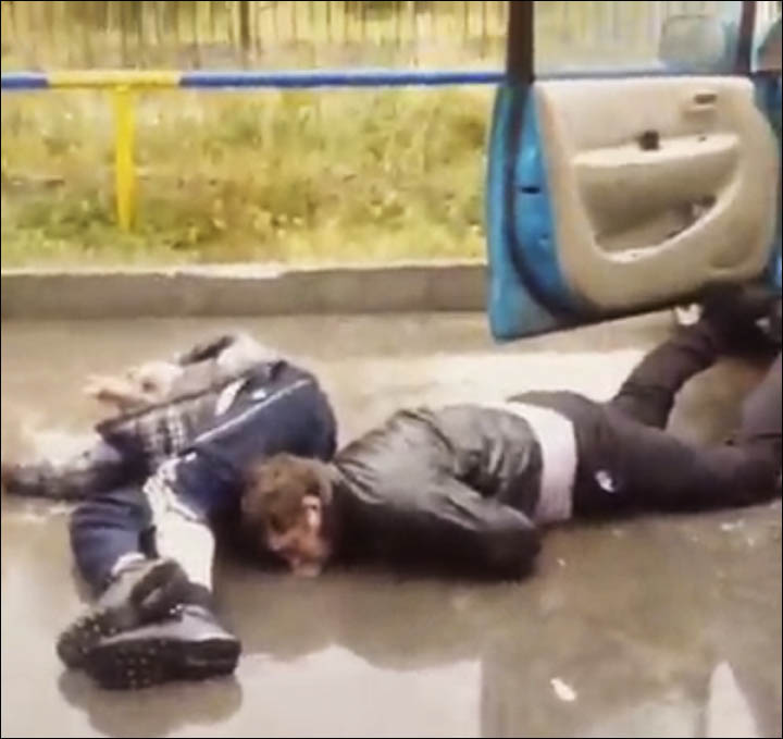 Two men are lying on the ground