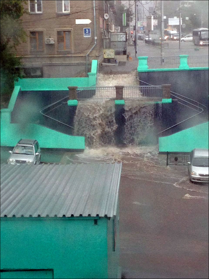 Deluge hits Siberia's largest city, causing 'waterfall' near city's railway station 