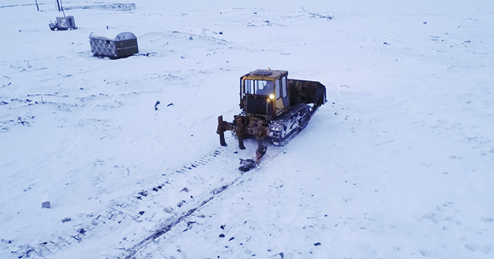 Tractor carries away the carcass