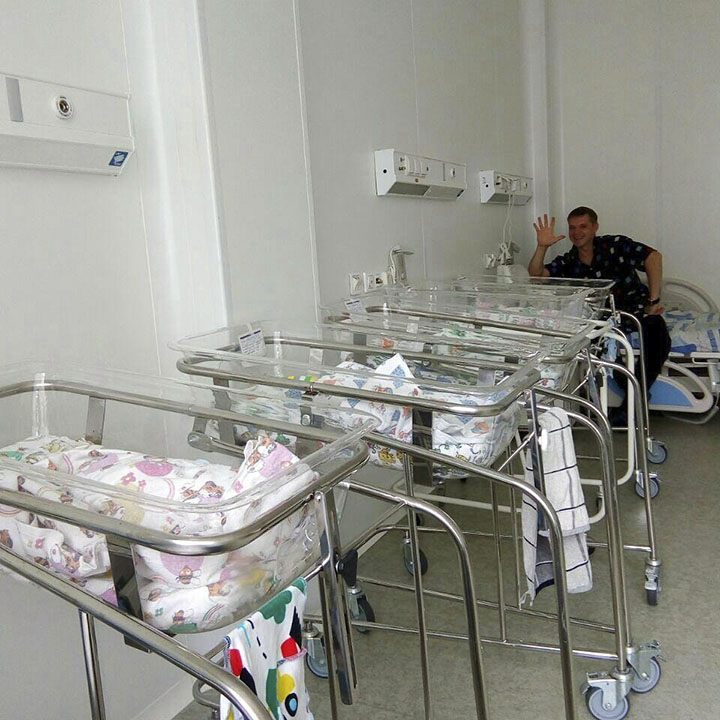 Father with kids in maternity hospital