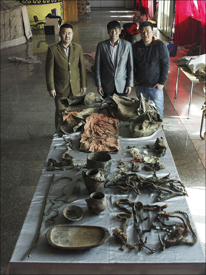 In the mummy's grave archeologists found - alongside the human remains - a saddle, bridle, clay vase, wooden bowl, trough, iron kettle, the remains of entire horse, and four different 'Dool' (Mongolian clothes). Pictures: Khovd Museum