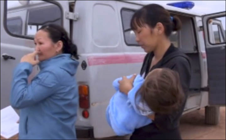 Karina carried to the car of rescuers