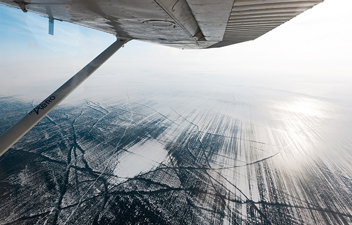 Moment plane lands on frozen surface of the world’s deepest lake