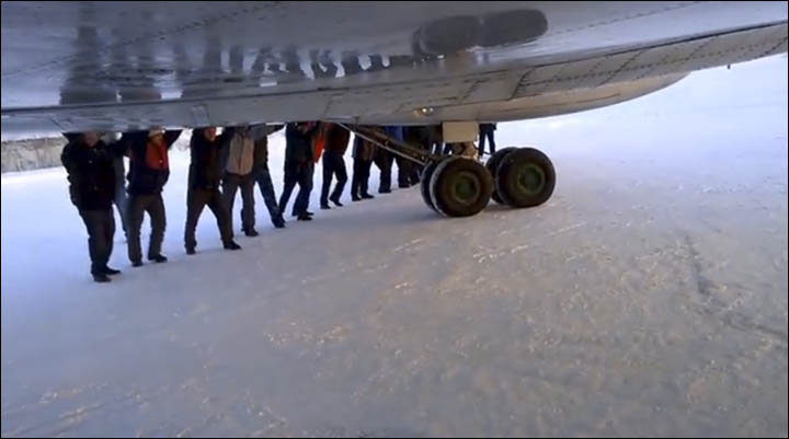 Men pushing aircraft