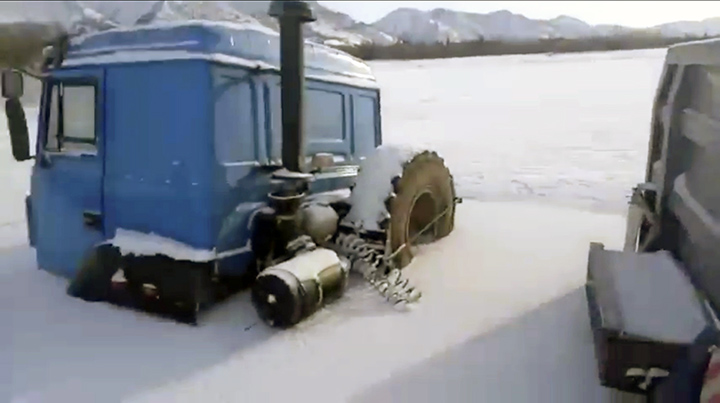 Heavy trucks of silver mining company in Yakutia get stuck in ice of river Tumara