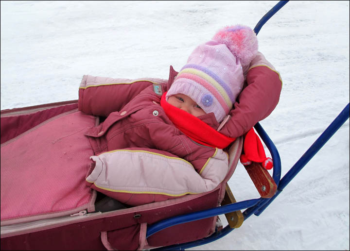 British baby enjoys her first sleigh rides in remote Siberian village where she is being raised 